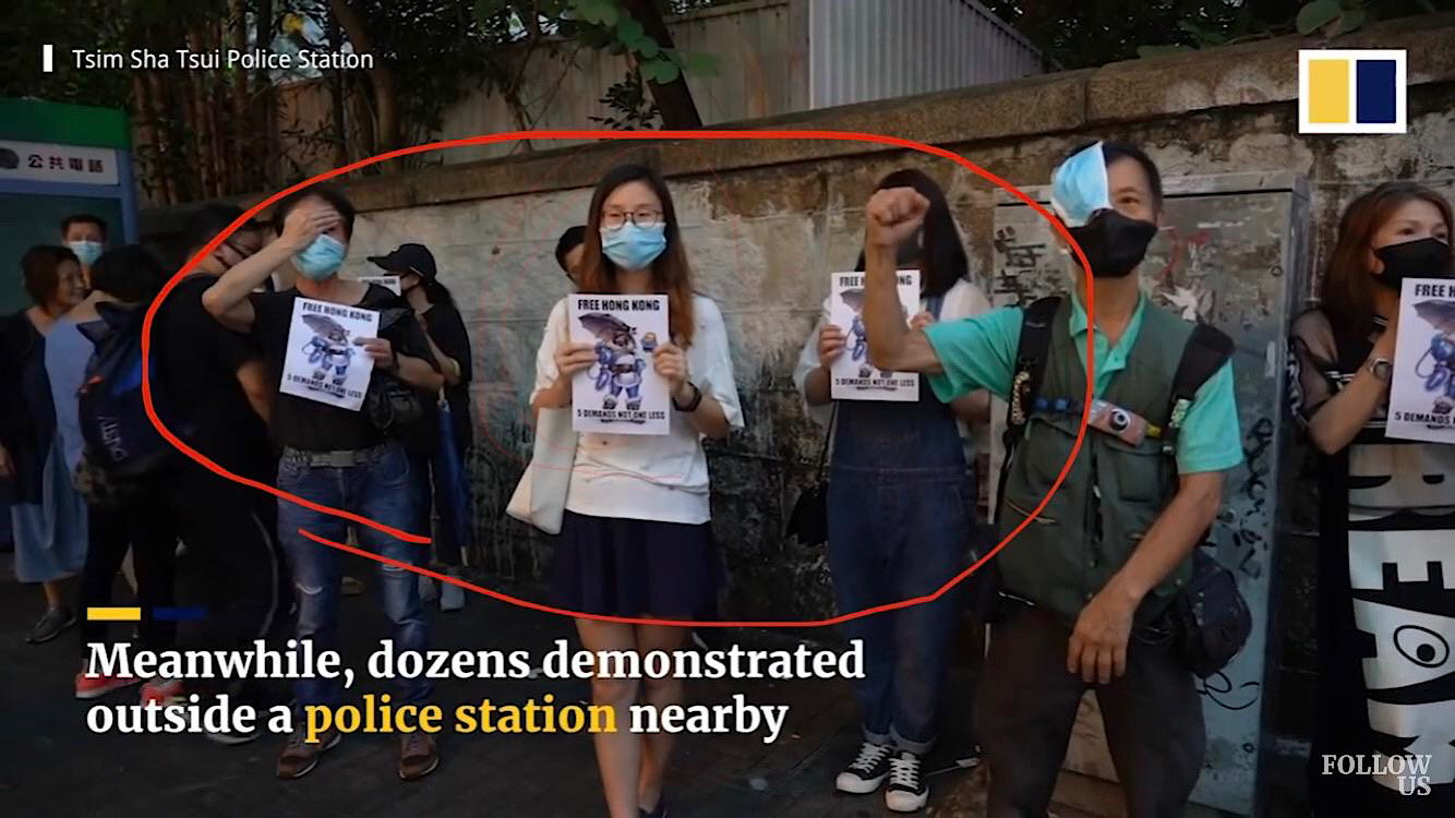 Pro-democracy Mei signs being held by Hong Kong protestors during a South China Morning Post broadcast.