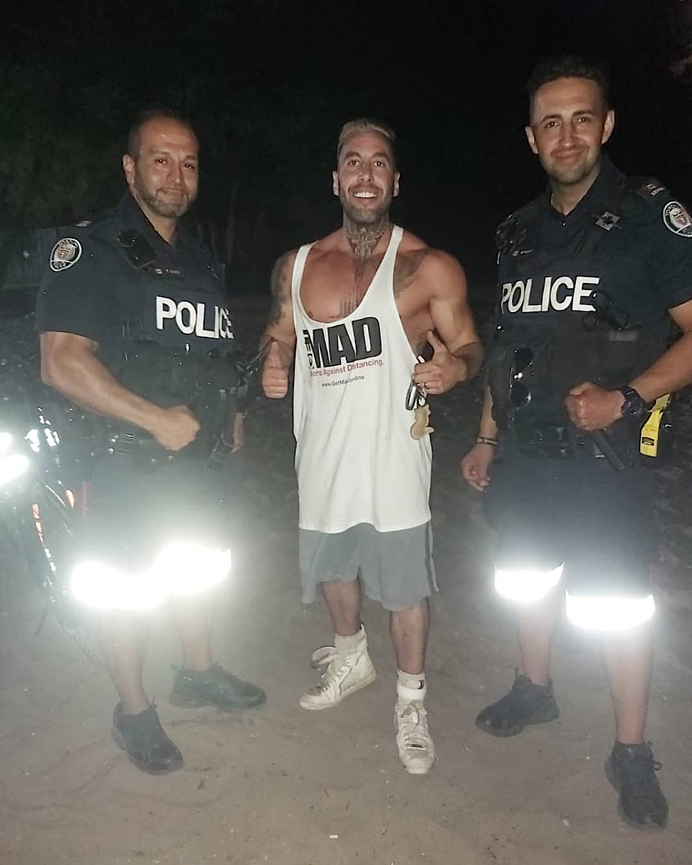 Toronto police is investigating this photo of two officers with Chris Sky (Instagram - @meet.the.skys)