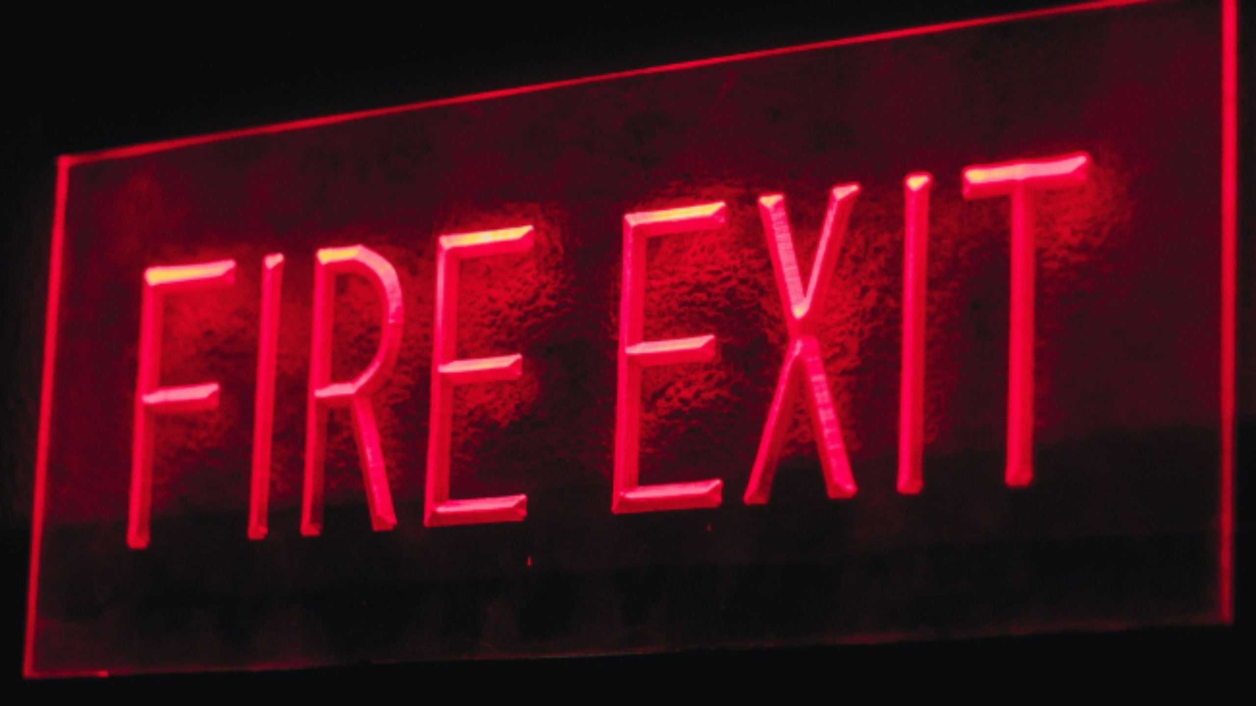 "Fire Exit" sign illuminated in red.