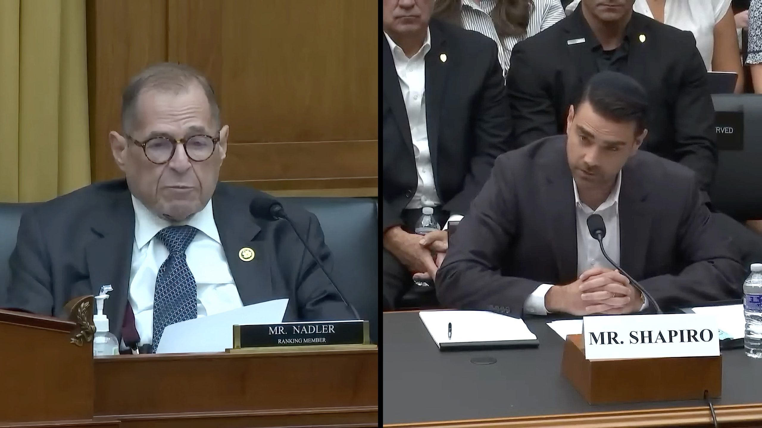 Two men at a formal meeting, with one labeled "Mr. Nadler" and the other "Mr. Shapiro," sitting at tables with microphones in front of them.