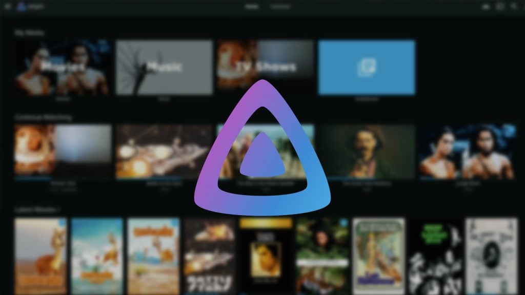 Triangular logo in blue and purple hues on a blurred media streaming interface background displaying movies, music, TV shows, and other media options.