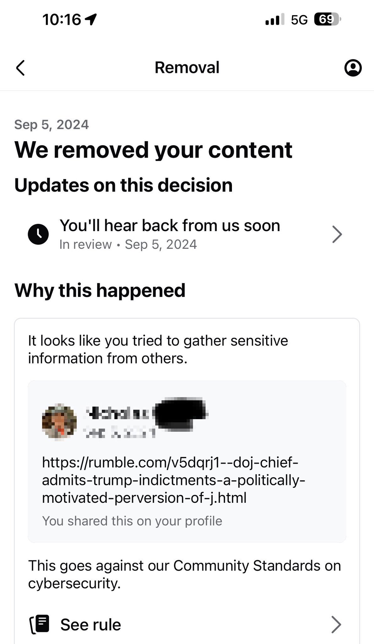 Notification of content removal for violating cybersecurity community standards, including a blurred-out link and profile information.