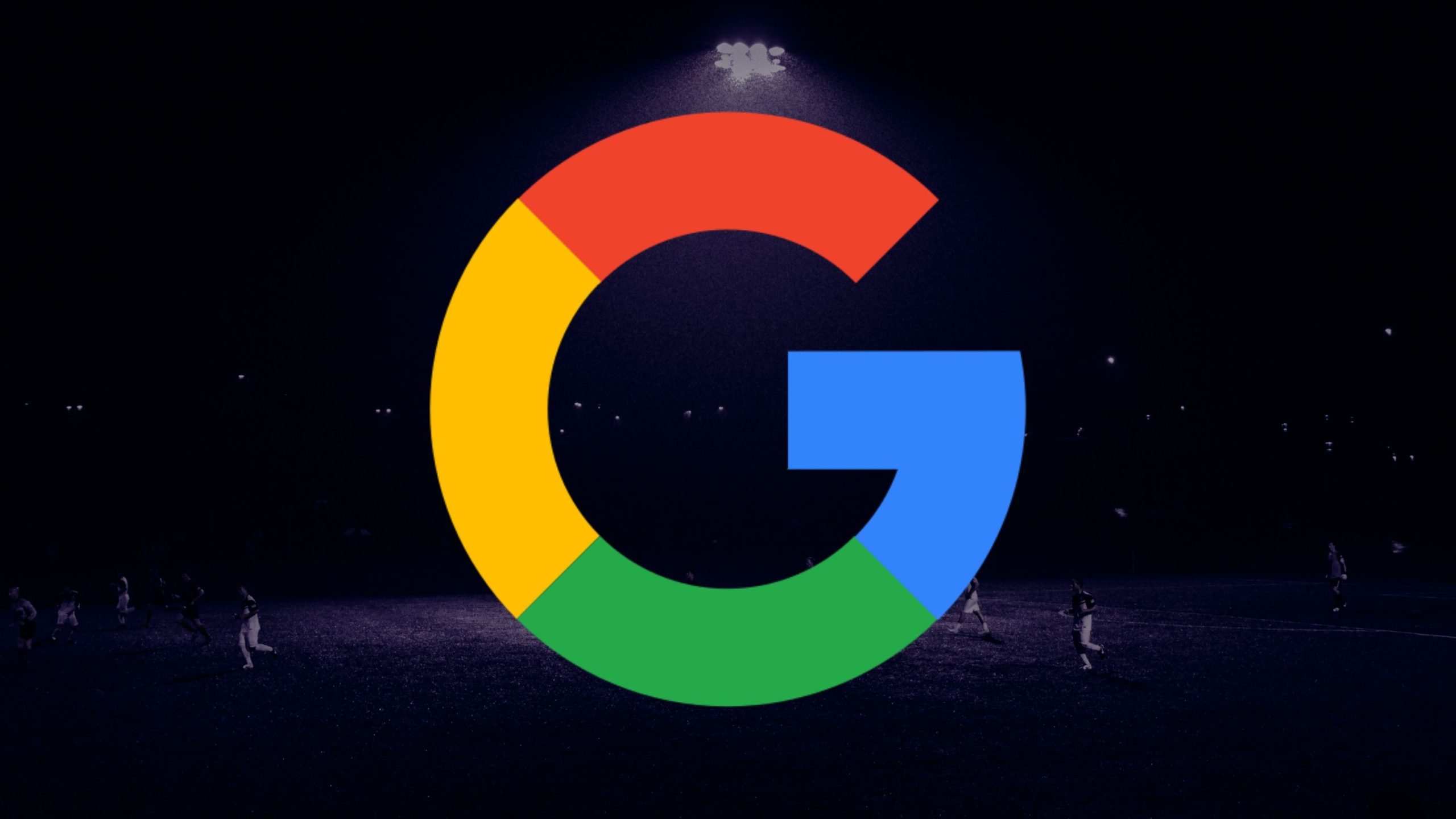 Google logo over a dark background with people playing soccer under floodlights.