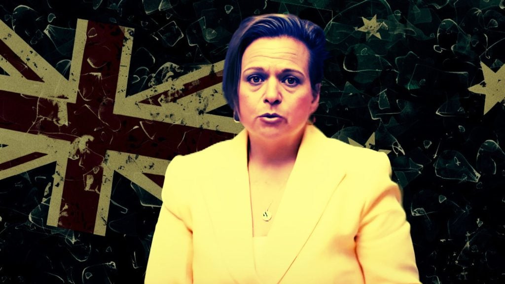 Michelle Rowland in a yellow blazer in front of a worn-out Union Jack flag background.