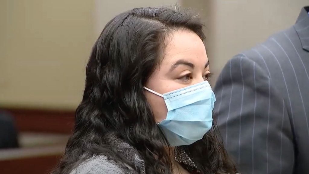 Senator Mary Cavanagh wearing a face mask and standing indoors.