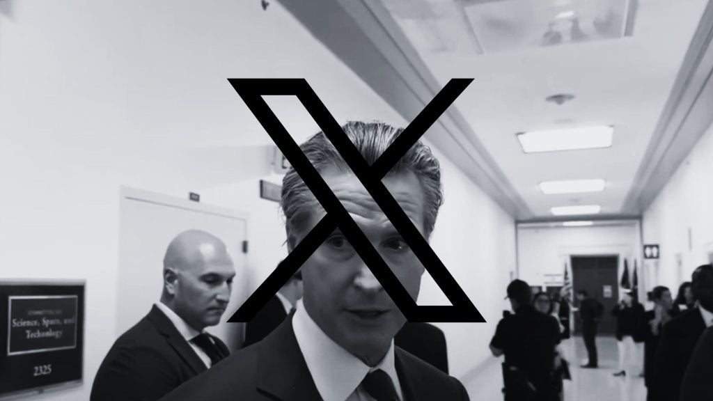 Gavin Newsom in a hallway, obscured by a large "X" symbol over his face.