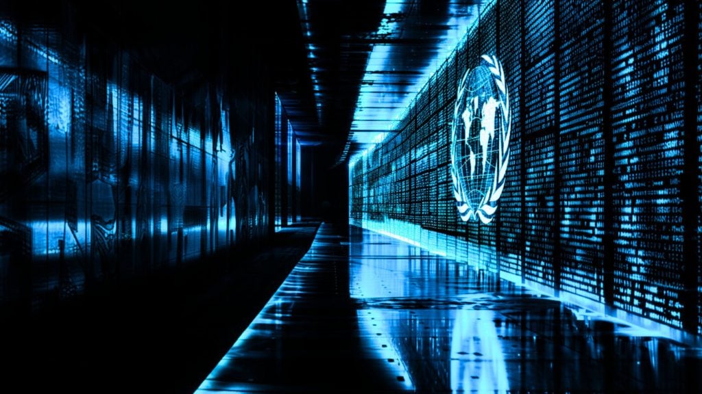 A futuristic corridor with glowing blue lights, digital text on the walls, and a world map insignia.