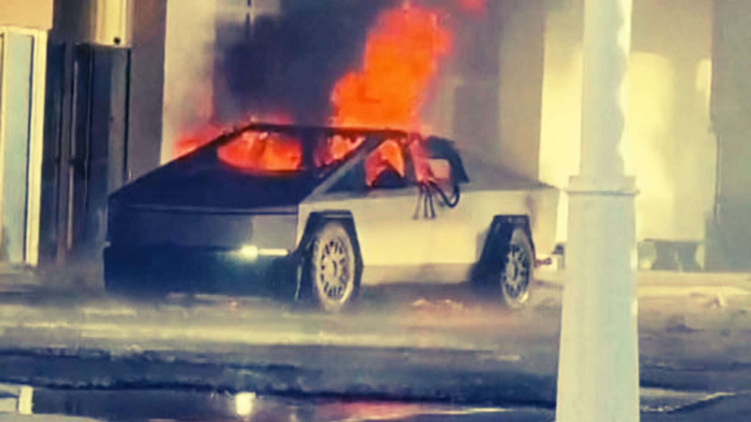 A Cybertruck engulfed in flames inside a structure.