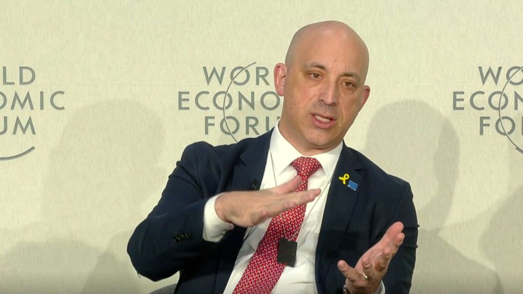 Greenblatt in a suit speaks at the World Economic Forum, gesturing with his hands.