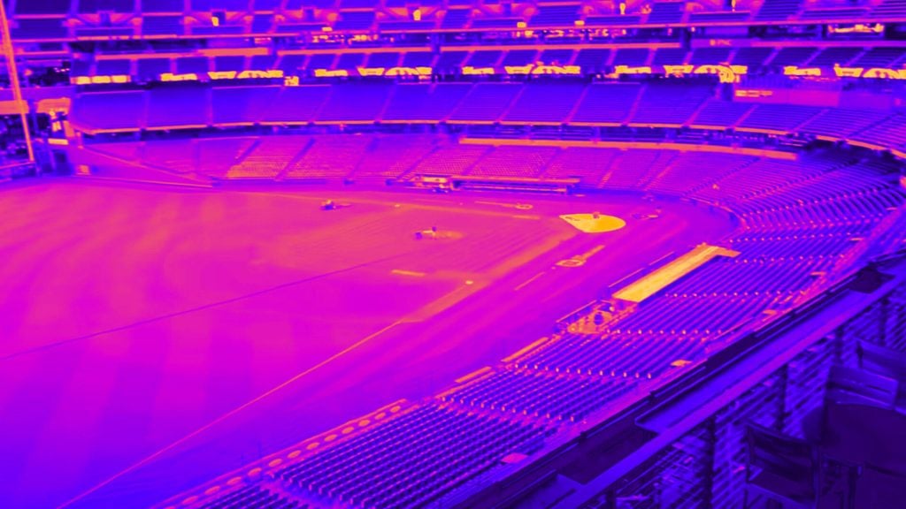 Thermal image of an empty baseball stadium with vivid purple and orange hues.