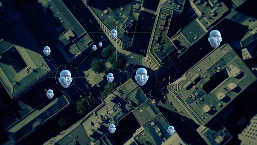 Aerial view of a city street with digital human heads overlaid, connected by lines, representing a network or surveillance concept.