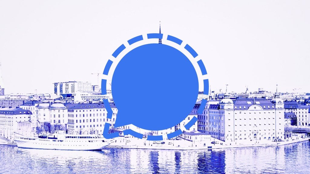 A large blue speech bubble logo overlaid on a cityscape featuring water, buildings, and a ship in monochrome blue tones.