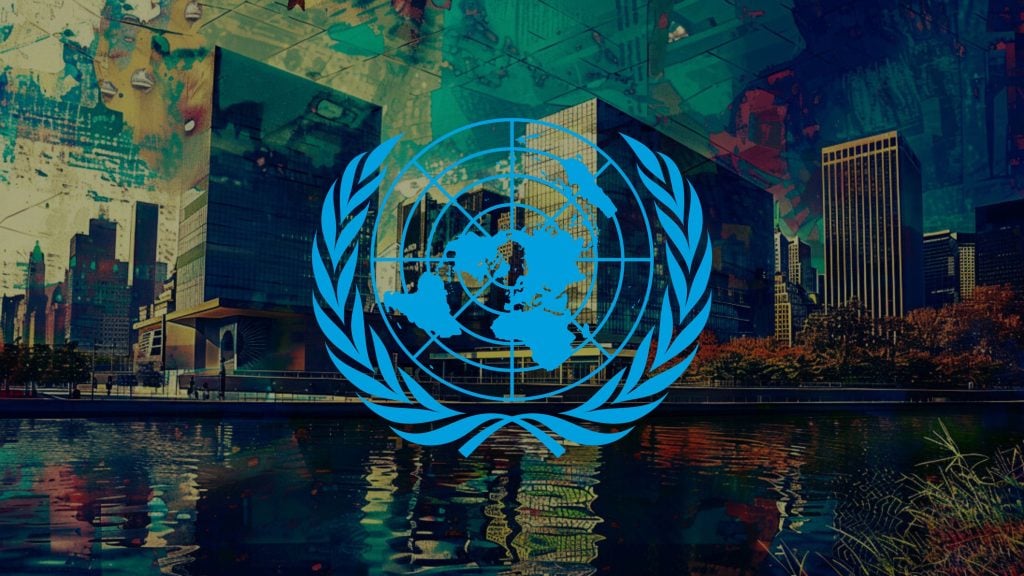 United Nations logo overlaid on an abstract cityscape background with water reflections.