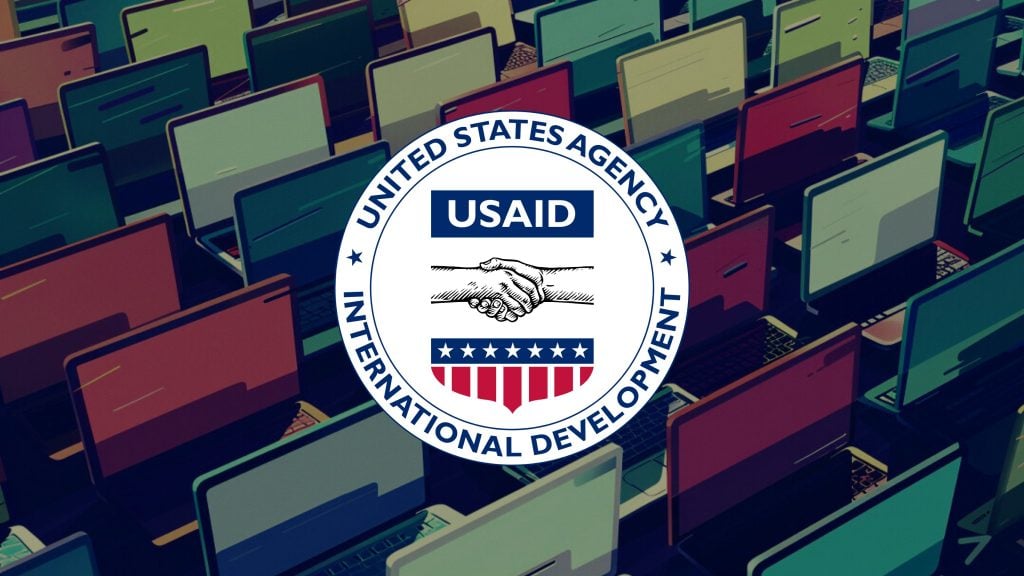 USAID logo overlaid on an illustration of rows of laptops with colorful screens.