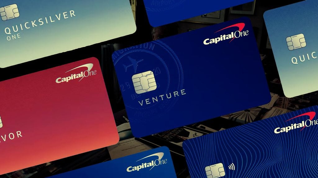 Several credit cards featuring the Capital One logo, including Quicksilver, Venture, and Savor, displayed against a dark background.