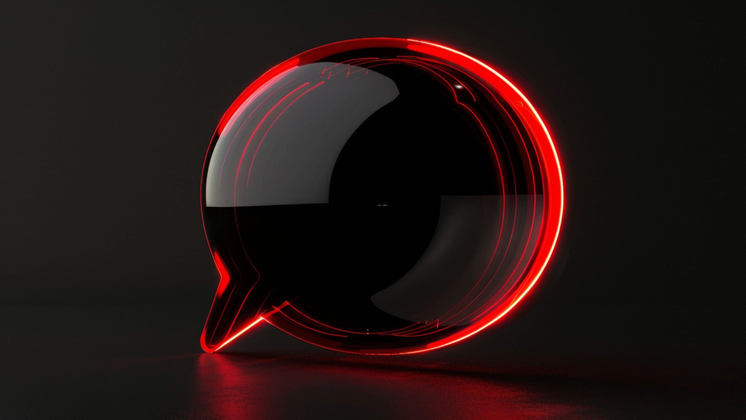 Glossy black speech bubble illuminated by a red neon outline on a dark background with a reflective surface.