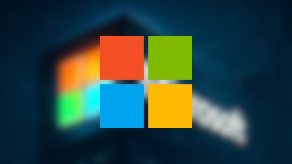Microsoft Windows logo with four colored squares (red, green, blue, yellow) in front of a blurred dark background.