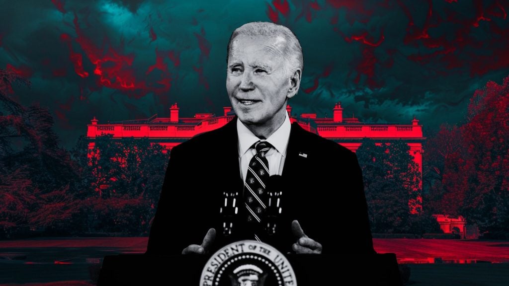 Black and white image of Biden in suit speaking at a podium with the presidential seal, with a stylized red and dark blue background showing the White House and dramatic sky.