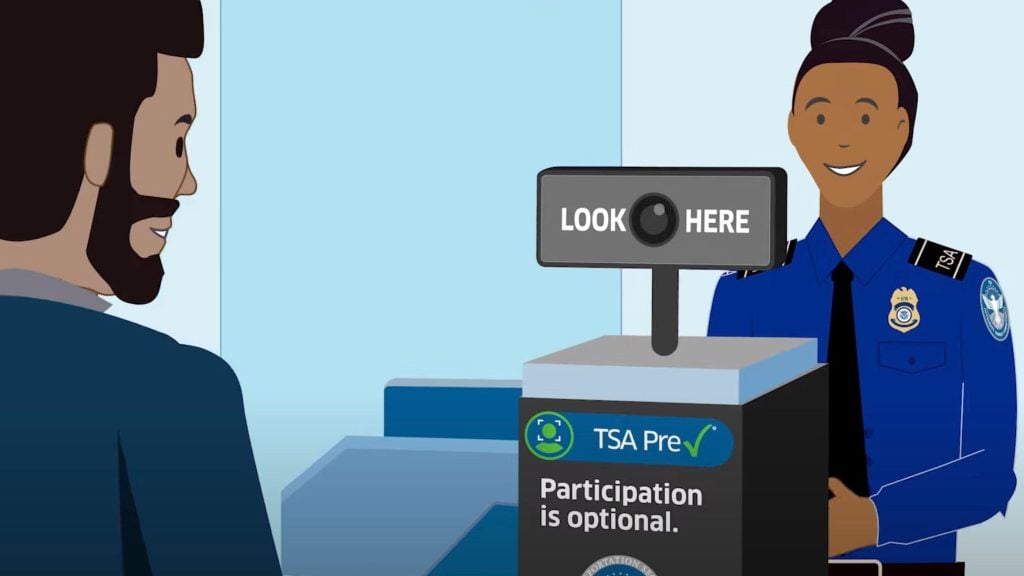 Illustration of a TSA officer smiling next to a TSA PreCheck scanning device that says LOOK HERE and Participation is optional, with a man standing nearby.