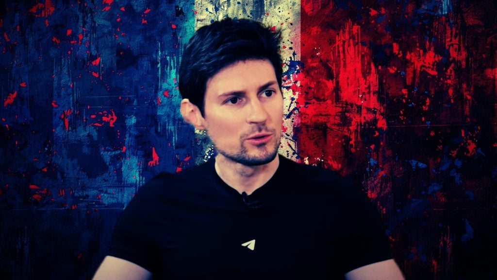 Durov with short dark hair and light facial hair wearing a black shirt with a white paper plane logo, against a colorful abstract background with blue, white, and red vertical paint splatters