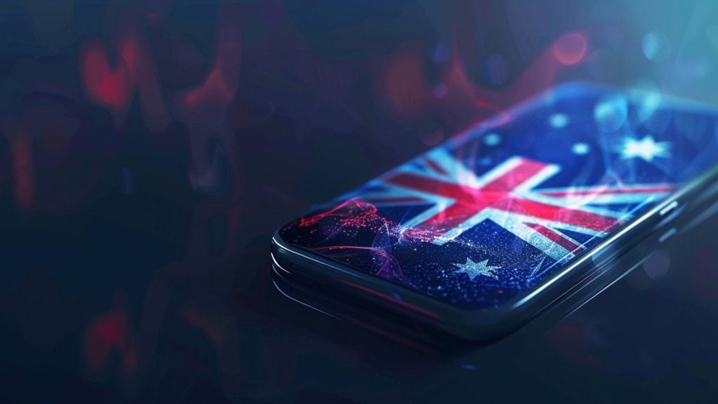 Smartphone displaying the Australian flag on its screen with a dark, blurred background and glowing light effects.