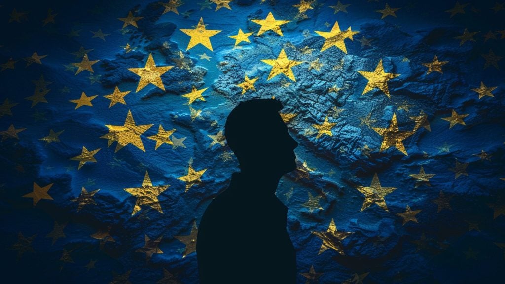 Silhouette of a person in profile against a textured blue background overlaid with multiple yellow stars, resembling the flag of the European Union.