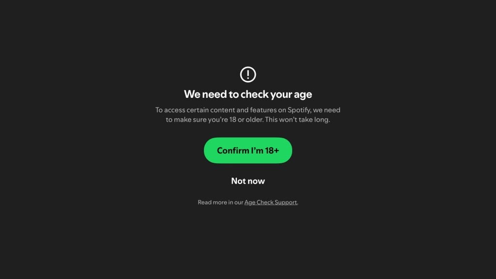 Age verification prompt on a dark background with a warning icon, asking to confirm if the user is 18 or older to access content on Spotify, featuring a green button that says "Confirm I'm 18+" and an option below labeled "Not now" along with a link to Age Check Support.
