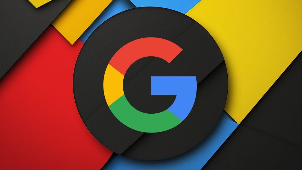 Multicolored Google 'G' logo centered on a textured black circular disk over layered red, blue, yellow, and black geometric paper-like shapes.