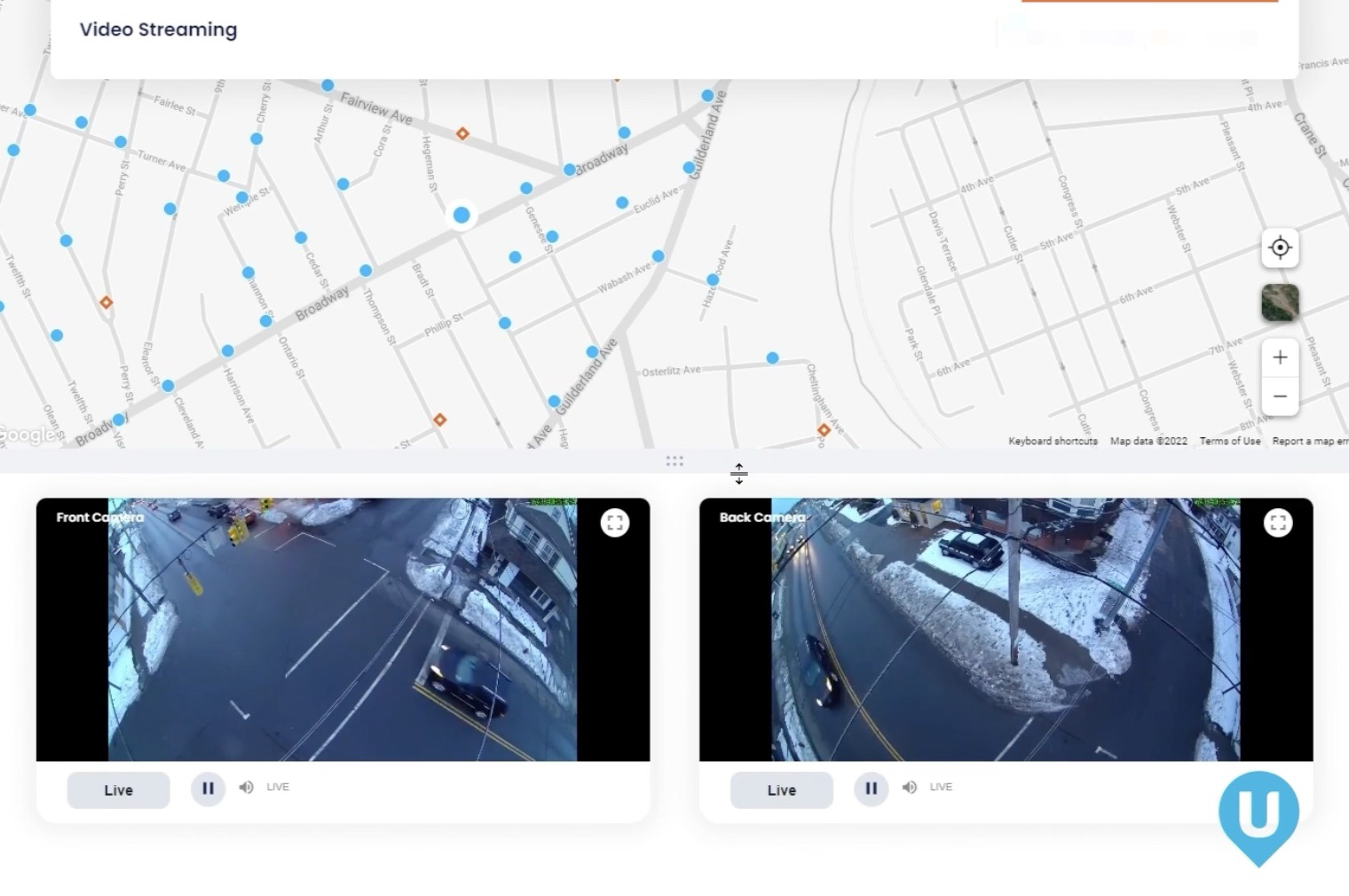 Map with blue location markers over a gray street grid above two side-by-side live video feeds labeled “Front Camera” and “Back Camera” showing high-angle views of a snow-lined intersection with moving cars and playback controls below, and a blue U logo in the bottom-right corner.