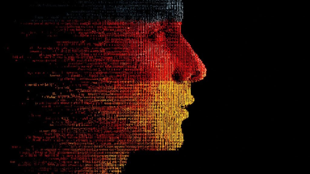 Side profile of a human face created from vertical lines of text and code in black, red, and yellow colors resembling the German flag on a black background