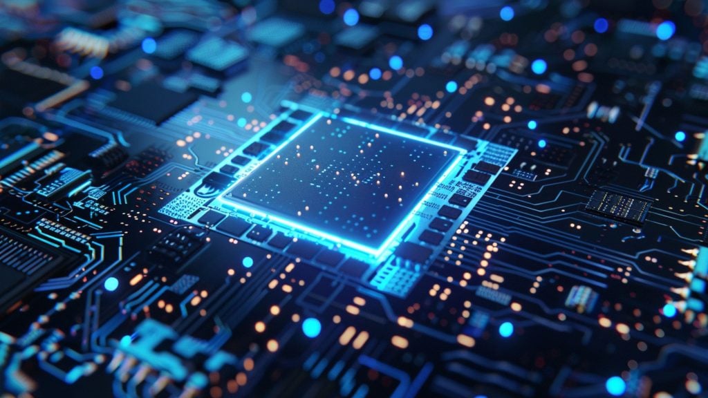 Close-up of a glowing blue computer chip mounted on a dark circuit board with intricate pathways and small lights indicating electronic components.