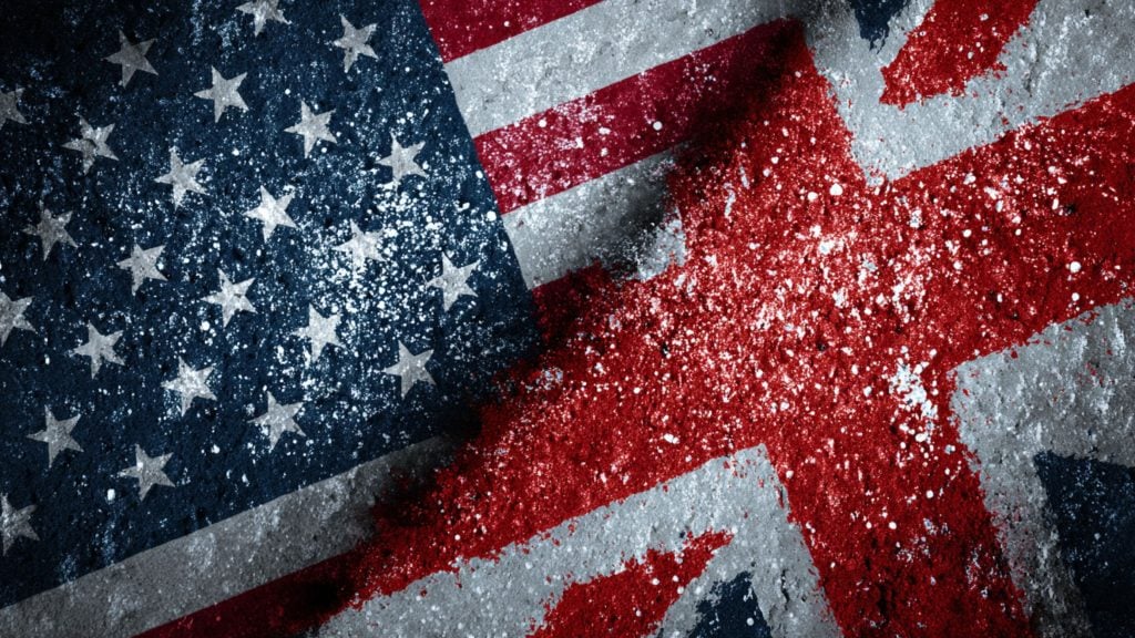 Close-up of a distressed collage showing the American flag's blue field with white stars blended with a worn, paint-splattered Union Jack red cross on a rough concrete texture.