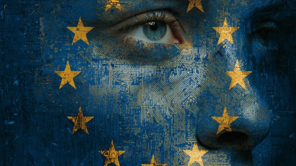 Close-up of a person's face textured with blue circuit-board patterns and overlaid with yellow European Union stars, focusing on a blue eye and the nose.