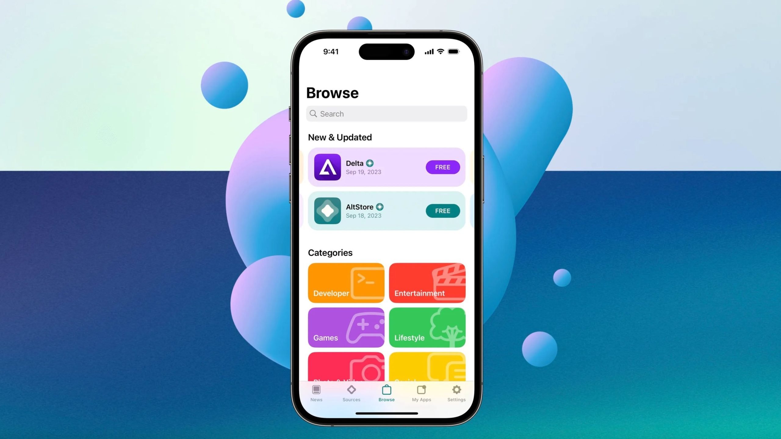 Centered iPhone against a teal-to-blue gradient with floating purple-blue spheres, displaying a Browse app store screen with a search bar, a New & Updated section listing Delta and AltStore with FREE badges, and colorful category tiles for Developer, Entertainment, Games, and Lifestyle.