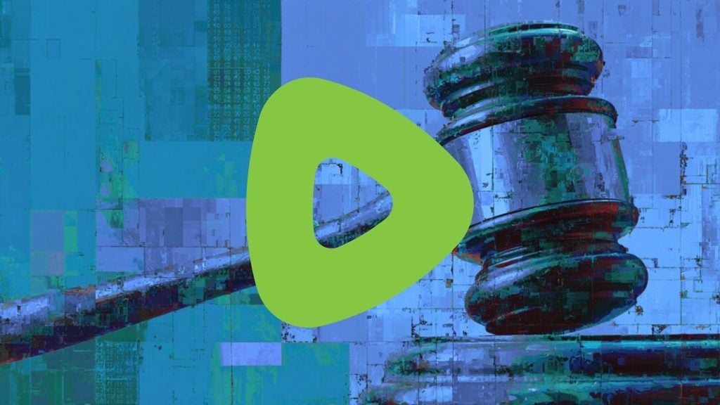 Rumble logo, rounded triangular play button centered over a stylized, pixelated blue-green depiction of a judge's gavel and striking block.