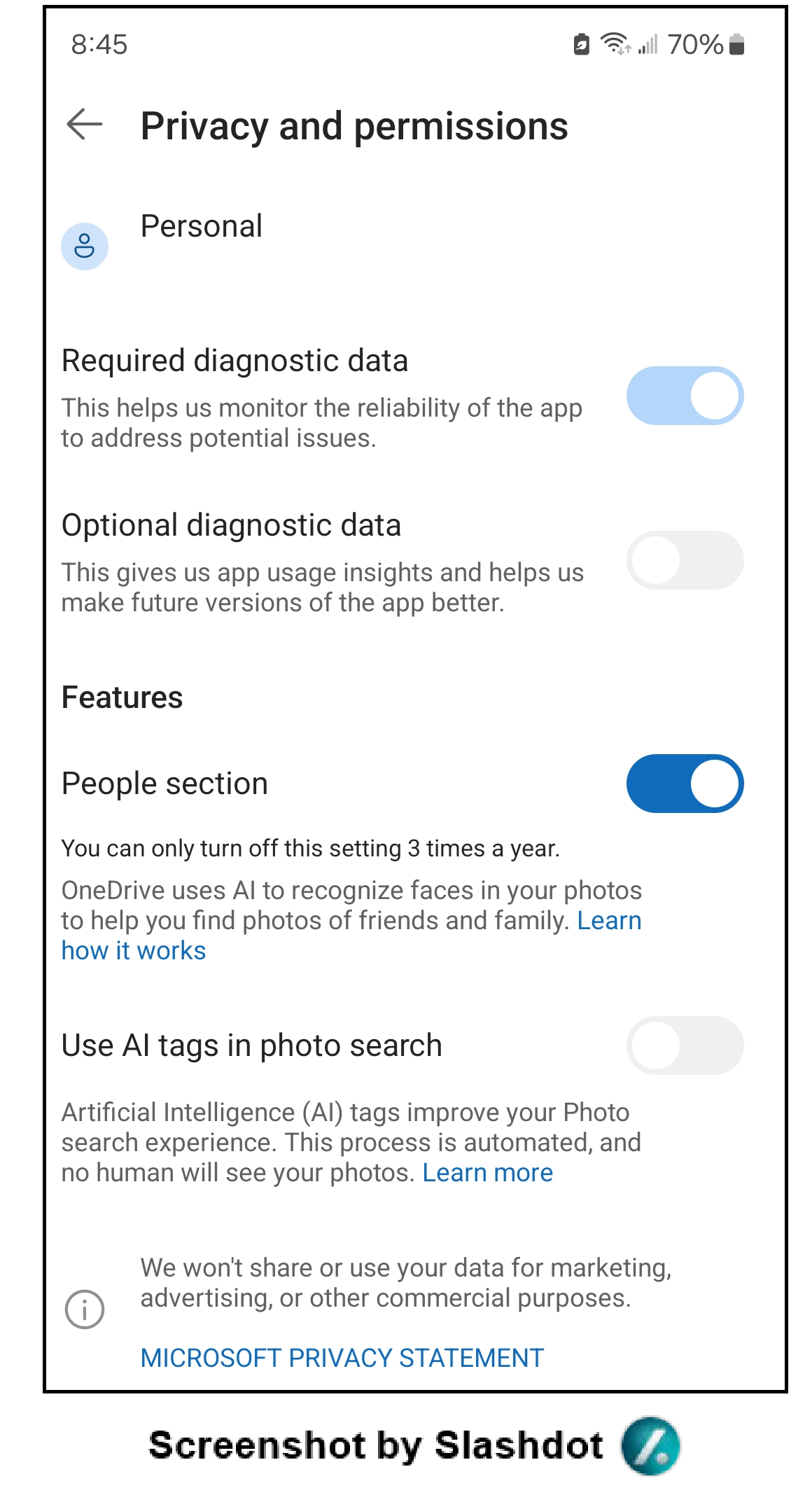 Mobile screenshot of a "Privacy and permissions" settings page showing a back arrow and profile icon, with toggles: "Required diagnostic data" on, "Optional diagnostic data" off, "People section" on with a note that OneDrive uses AI to recognize faces, and "Use AI tags in photo search" off, plus a Microsoft Privacy Statement link and a "Screenshot by Slashdot" watermark at the bottom.