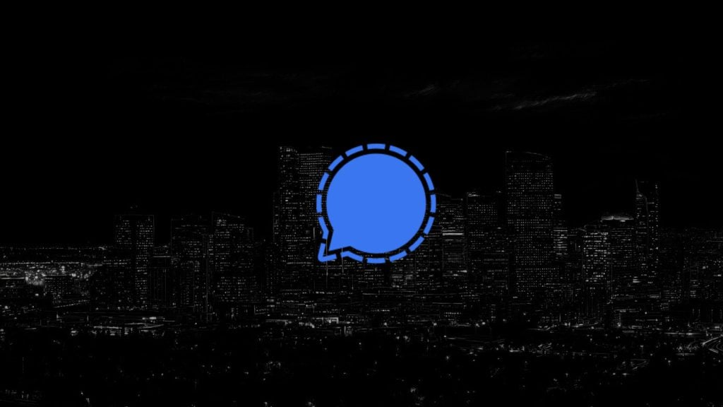 Signal speech-bubble icon with a dashed circular outline centered over a dark, high-contrast nighttime city skyline.