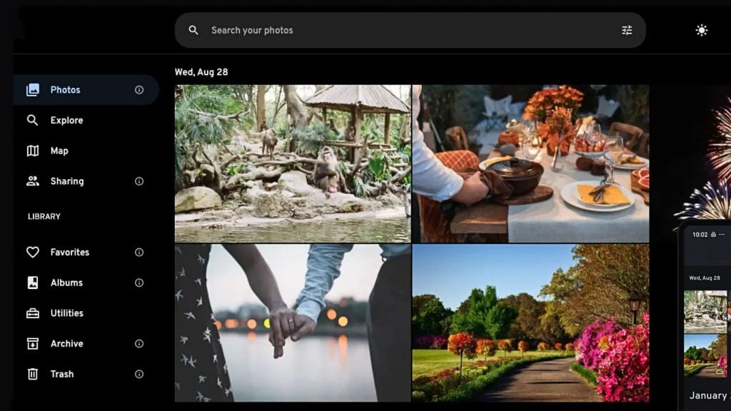 Screenshot of a photo gallery app showing a dark left navigation menu and a top search bar, with a four-photo grid featuring monkeys by water, a festive table setting with orange flowers, a couple holding hands, and a flower-lined park path, plus a narrow phone thumbnail column and fireworks at the right edge.