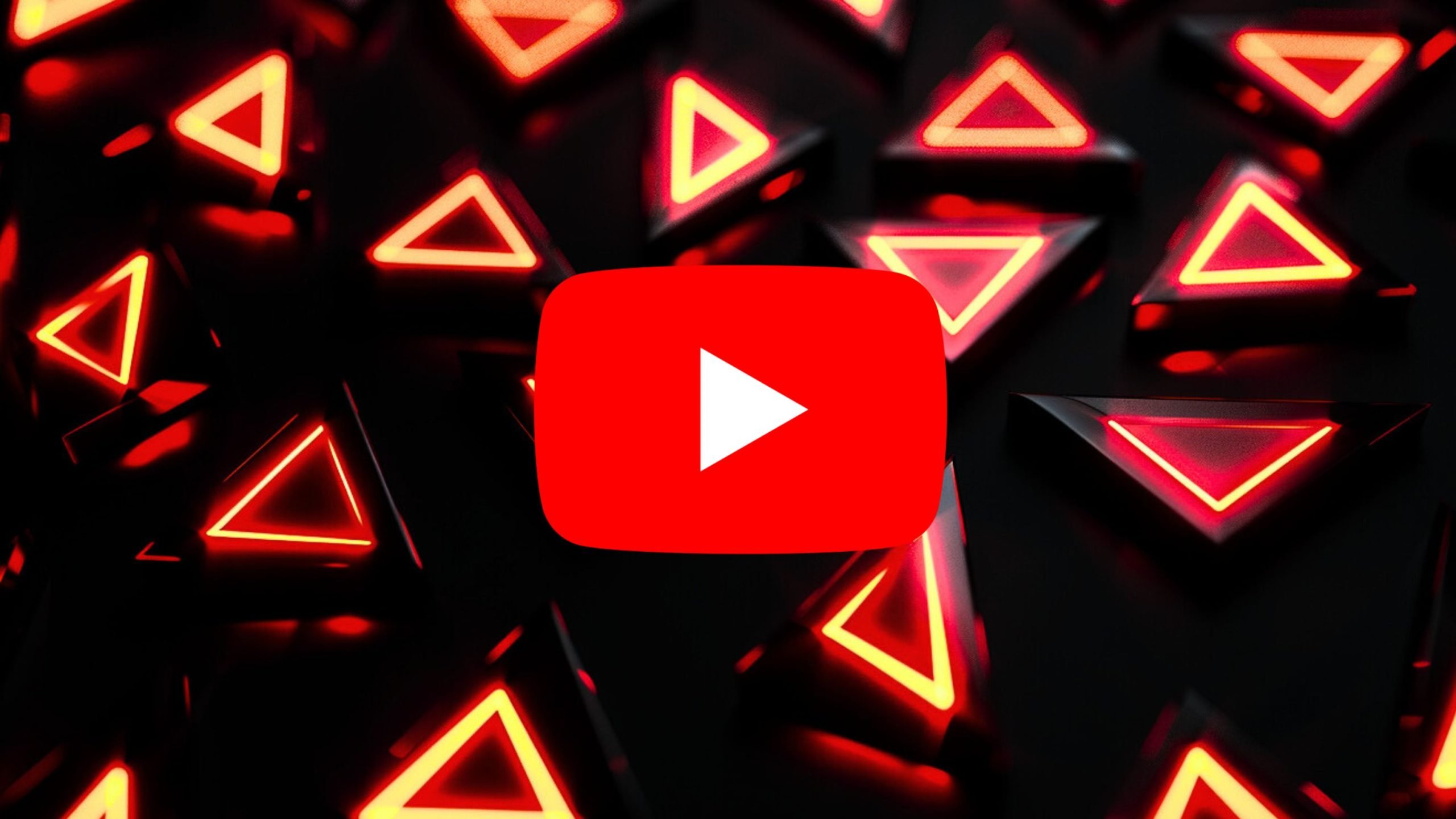 Centered large red YouTube play icon with a white play triangle over a dark field of scattered black triangular prisms glowing with neon red triangular outlines.