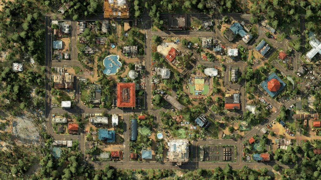 Aerial view of a compact, tree-lined neighborhood in a loose grid with roads and parking, mixed residential and civic buildings including a red-roofed square building, a blue-roofed octagonal pavilion, several swimming pools and playgrounds, and dense forest surrounding the area.