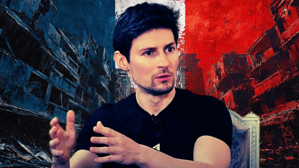 Pavel Durov with light stubble wearing a black T‑shirt, seated and gesturing with both hands against a stylized blue‑white‑red vertical background with ruined urban buildings on the blue and red sides.