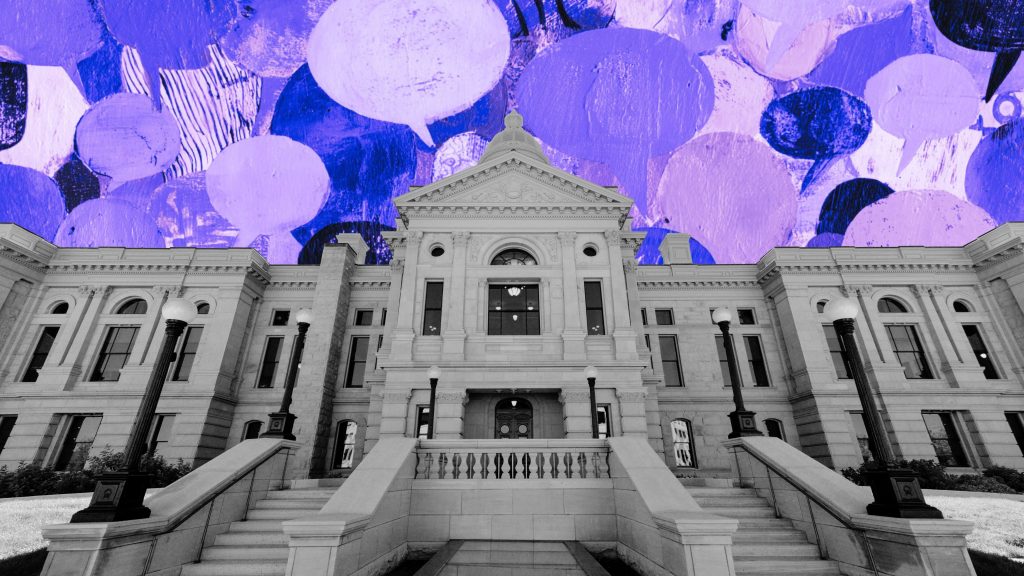 Frontal view of a neoclassical stone government building with a central pediment, small dome, wide balustraded staircase and tall lamp posts rendered in grayscale against a vivid purple painted collage of speech-bubble shapes filling the sky.