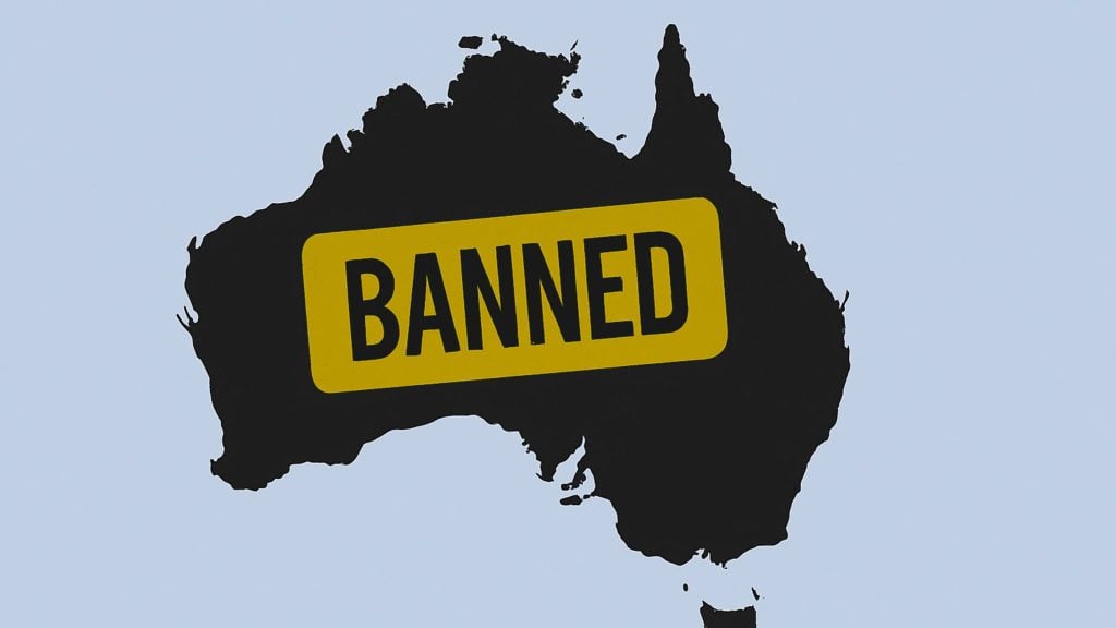 Black silhouette map of Australia on a pale blue background with a yellow rectangular stamp across it reading BANNED.