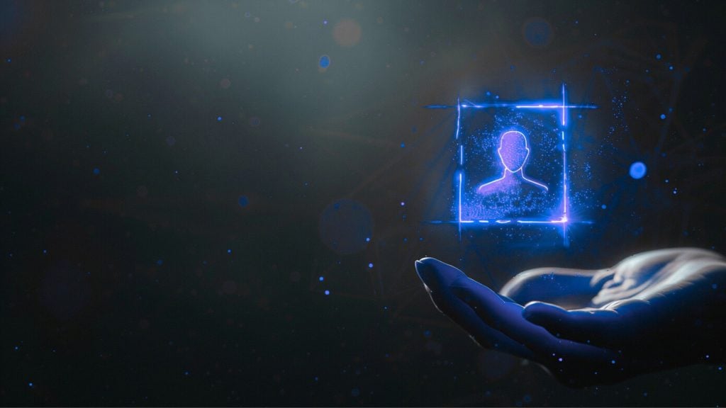 Open hand holding a glowing blue holographic user avatar inside a neon square against a dark, starry background.