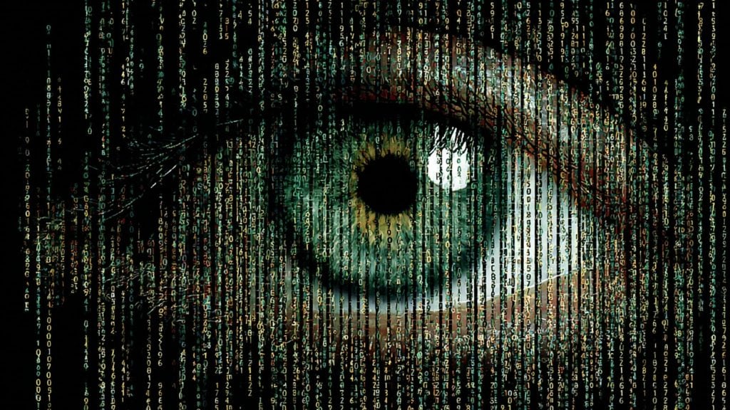 Close-up green eye overlaid with cascading green and yellow matrix-style code.