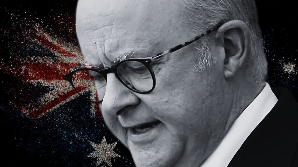 Close-up grayscale profile of an elderly Albanese wearing round glasses against a stylized Australian flag splattered background.
