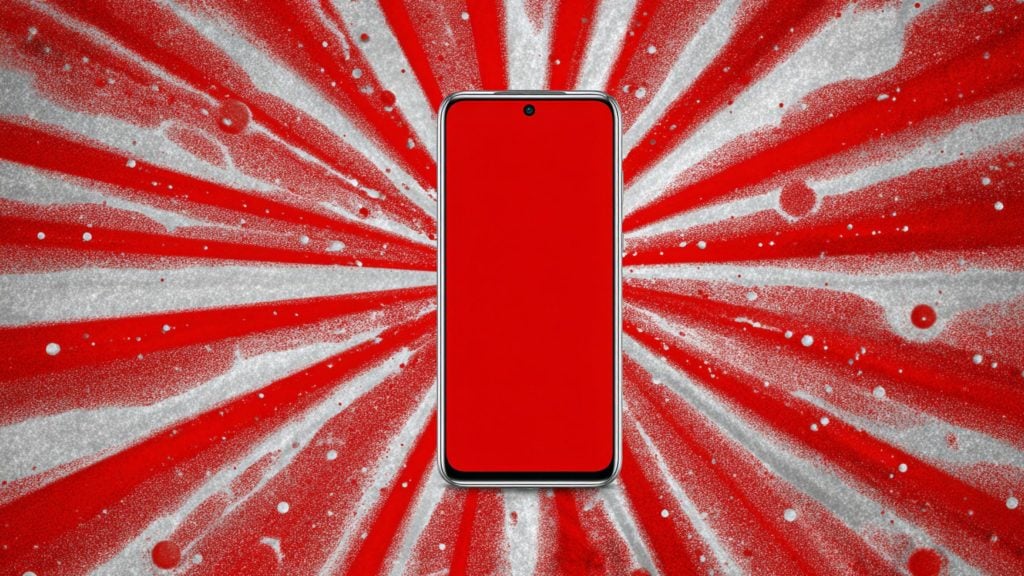 Phone with solid red screen and centered punch-hole camera in silver bezel on a red-and-white spray-painted radial background.