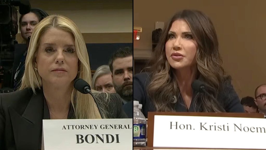 Split-screen of Bondi and Noem at a hearing, a blonde left and brunette right at microphones with visible nameplates.
