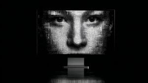 Close-up black-and-white halftone face displayed on a large screen above a minimalist pedestal in a dark room.