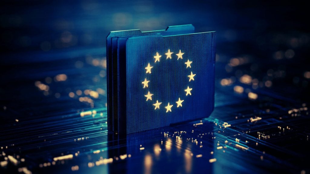 Stack of glowing blue circuit-board folders with a ring of yellow EU stars on the front, set on a reflective motherboard surface